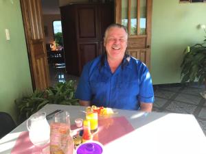 a man sitting at a table with a plate of food at La Princesa Hotel in San Isidro