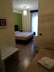 Posteľ alebo postele v izbe v ubytovaní Hotel Bruman