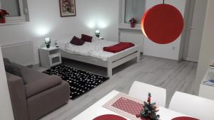 a small living room with a bed and a couch at Home Away From Home - Apartment Ilica in Zagreb
