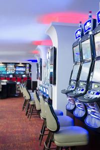 a row of video game machines in a casino at Taormina Hotel and Casino-Adults Only in San José