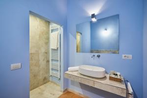 bagno blu con lavandino e specchio di Villa Socini a Siena