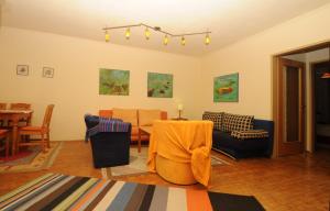 a living room with a couch and a table at Kandolf Apartments Klagenfurt in Klagenfurt