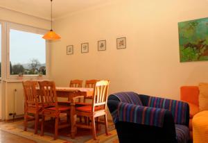 a dining room with a table and chairs at Kandolf Apartments Klagenfurt in Klagenfurt