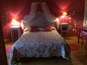 a bedroom with a large bed with red walls at Chambres d'Hôtes Gelous in Bidache +13 photos