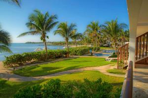 a view of the ocean from the balcony of a resort at Las Villas Akumal in Akumal