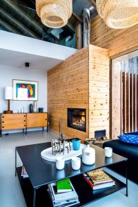 a living room with a table and a fireplace at Home by U - Chalet 5 in Saint-Martin-de-Belleville