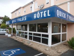 a hotel with a blue sign on the front of it at Quick Palace Poitiers in Chasseneuil-du-Poitou