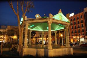 a gazebo on a city street at night at Hotel Emily in Pachuca de Soto
