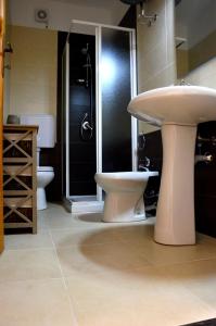 a bathroom with two toilets and a sink at Mille Soli Bed and Breakfast in Buggerru