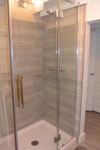 a shower with a glass door in a bathroom at Manoir Sainte Genevieve in Quebec City +153 photos