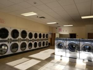 a row of washing machines in a laundry room at Western Budget Motel Ponoka in Ponoka