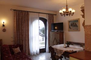 a living room with a table and a large window at Villa Moroder in Ortisei