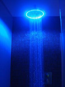 a shower with blue lights in a bathroom at Villa Moroder in Ortisei