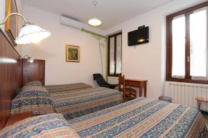A bed or beds in a room at Albergo Santo Spirito