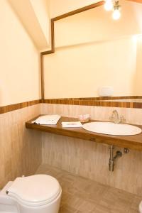 a bathroom with two sinks and a toilet at Park Hotel Villaferrata in Grottaferrata