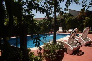 a swimming pool with a white scooter parked next to a swimming pool at Apart Hotel Sahara in Pinamar +51 photos