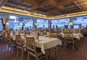 a banquet hall with white tables and chairs at Flims113 in Flims