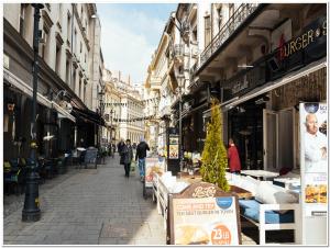 a city street with people walking down the street at Old Town Studio - Panoramic City View in Bucharest