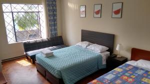 Кровать или кровати в номере Cozy and Comfortable Home in MIRAFLORES