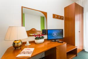 a desk with a computer and a lamp on it at Hotel Tegorzo in Fener