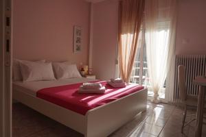 a bedroom with a large bed with towels on it at Aristotelous Square Luxury Apartment in Thessaloniki