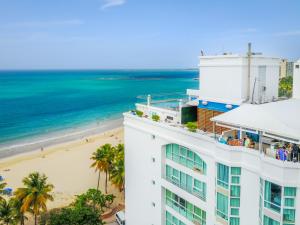 an aerial view of a building and the beach at San Juan Water & Beach Club Hotel in San Juan