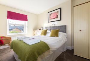 a bedroom with a bed with towels on it at Sunrise Guest House in Bude