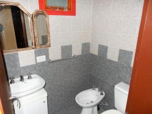 a bathroom with a toilet and a sink at Nido de Luna in El Calafate +88 photos