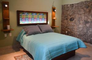 Postel nebo postele na pokoji v ubytování Hotel Las Candelas de Huamantla