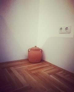 a vase sitting on the floor in a room at Kuca Jelena in Pale