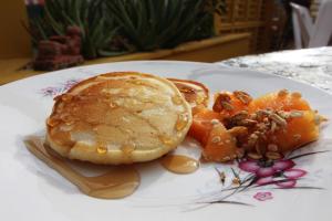 a plate of pancakes and fruit on a table at Hotel Mary Carmen in Cozumel