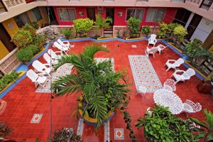 an aerial view of a patio with white chairs and tables at Hotel Mary Carmen in Cozumel