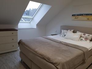 a bedroom with a large bed with a window at Achim bei Bremen gemütlich wohnen in Achim