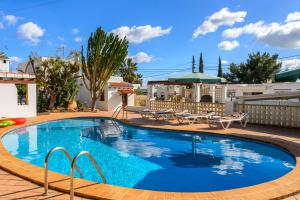 a large swimming pool with blue water in a yard at Villa Can Giovanni in Sant Jordi