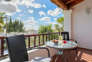 a balcony with a table and chairs and a view of the ocean at Villa Can Giovanni in Sant Jordi