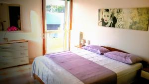 ガリポリにあるB&B Delfisのベッドルーム1室(紫色の枕が付くベッド1台、窓付)