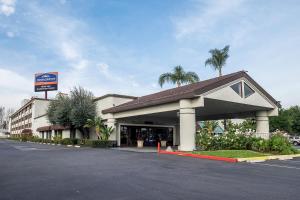 a large building with a sign on the side of it at Howard Johnson by Wyndham Fullerton/Anaheim Conference Cntr in Fullerton