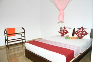 1 dormitorio con 1 cama y 1 silla en Nethmi Homestay, en Sigiriya