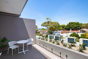 a balcony with a table and chairs on a building at Bondi Beach Studio Penthouse Suite + Balcony in Sydney