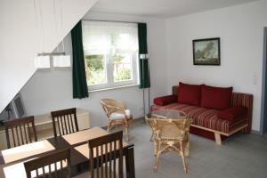 a living room with a couch and a table at Steinbock-Ferienwohnungen in Kolpinsee