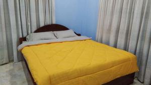 A bed or beds in a room at Bunyong Homestay