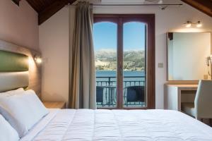 A bed or beds in a room at Hotel Aggelos Kefalonia