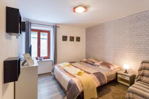 een slaapkamer met een bed en een bakstenen muur bij Apartment Antonio in Split