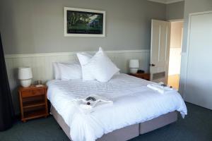 a bedroom with a large bed with white sheets and pillows at Valley View Luxury Retreat in Vacy
