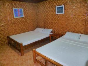 Ein Bett oder Betten in einem Zimmer der Unterkunft CasaKeja Inn