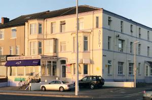 two cars parked in front of a building at Belmont Hotel in Blackpool