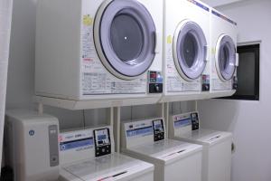 three washing machines are on display in a room at Grand Park Hotel Panex Tokyo in Tokyo