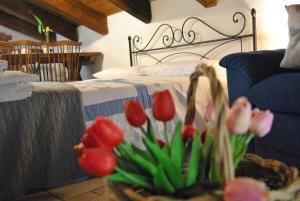 a bedroom with a bed with red and pink tulips at Mansarda romantica "Il nido delle rondini" in Conversano