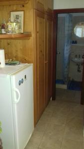 a kitchen with a white refrigerator and a sink at House Rasohatica Tare in Korčula
