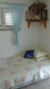 a bed sitting in a room with a window at House Rasohatica Tare in Korčula